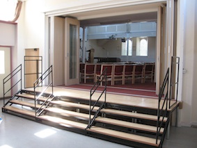 Through the portal you will find the steps down into the church hall. On the far side is a door to a lift for people who are less mobile. Alternatively, people can walk round the front of the building and in through the street entrance.